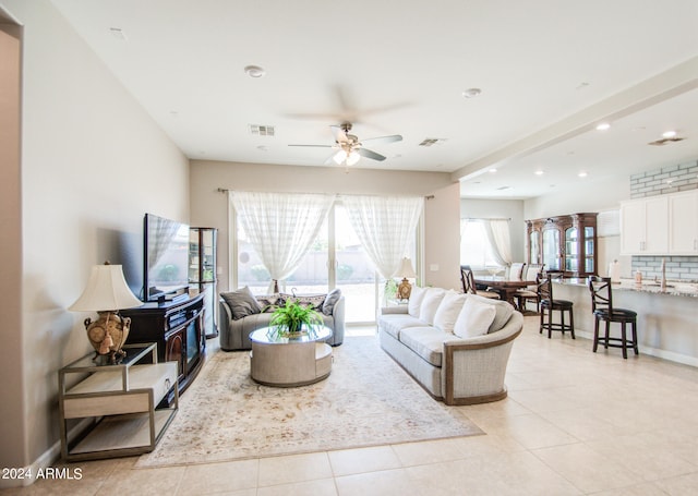 tiled living room with ceiling fan