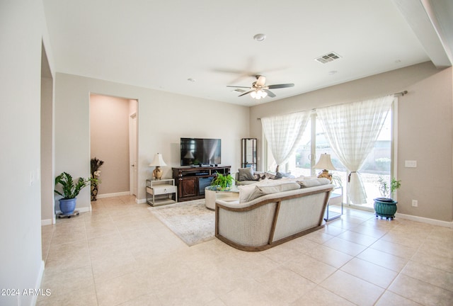 living room featuring ceiling fan and light tile patterned floors