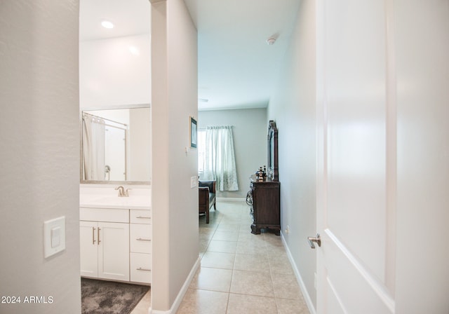 hall with light tile patterned flooring and sink