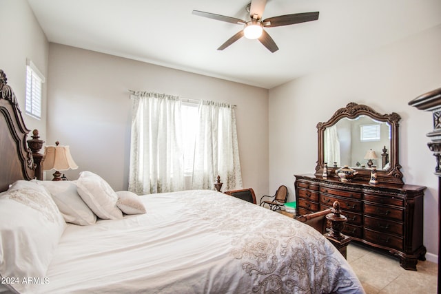 bedroom with multiple windows, light tile patterned floors, and ceiling fan