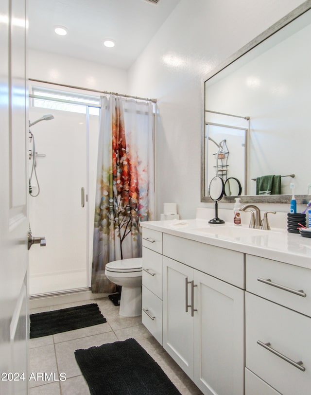 bathroom featuring vanity, curtained shower, toilet, and tile patterned flooring