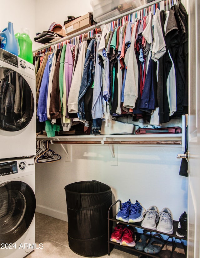 interior space with stacked washer and dryer and light tile patterned floors