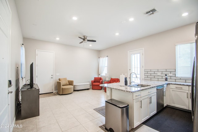 kitchen featuring kitchen peninsula, tasteful backsplash, white cabinetry, dishwasher, and sink