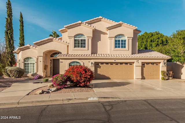 mediterranean / spanish-style house with a garage