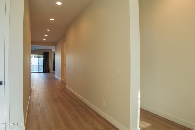 hall with wood-type flooring