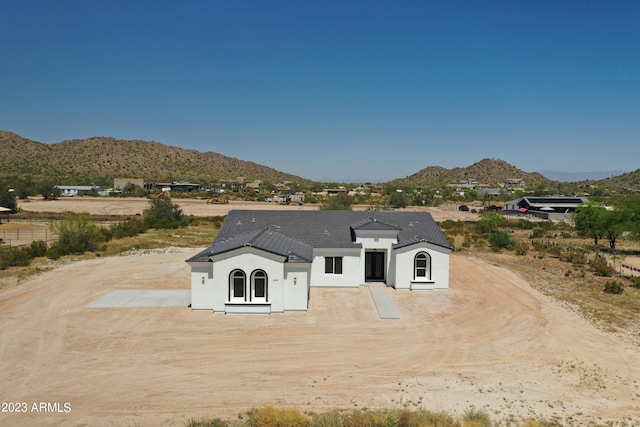 view of front of house featuring driveway, a mountain view, and stucco siding