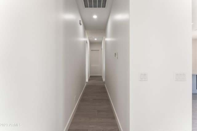 corridor featuring baseboards, recessed lighting, wood finished floors, and visible vents