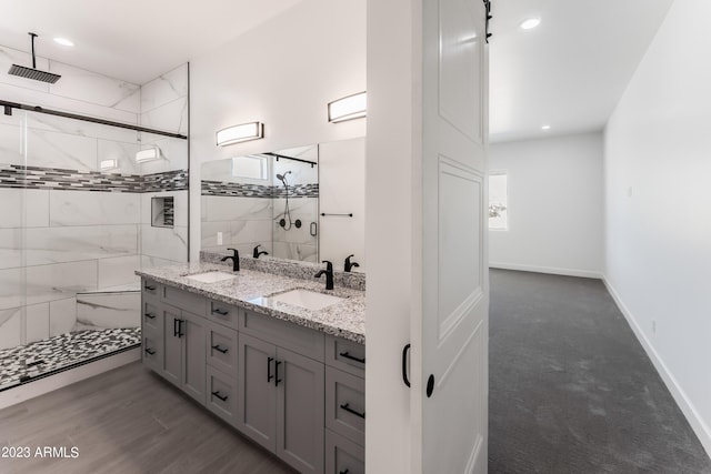 bathroom featuring double vanity, visible vents, a sink, and a stall shower