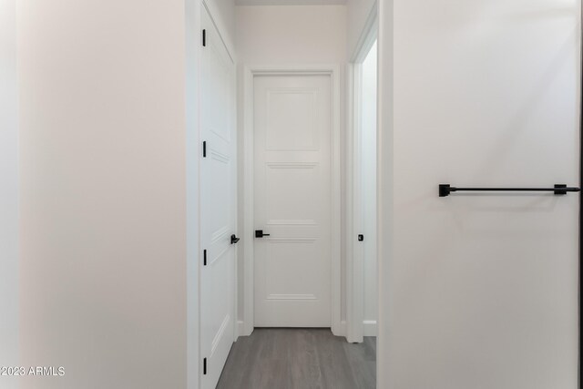 hallway featuring baseboards and light wood-style floors