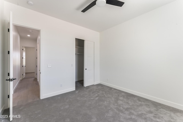 unfurnished bedroom featuring dark colored carpet, a ceiling fan, baseboards, and a closet