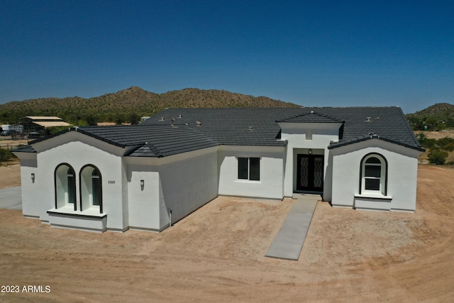 back of house featuring a mountain view and stucco siding