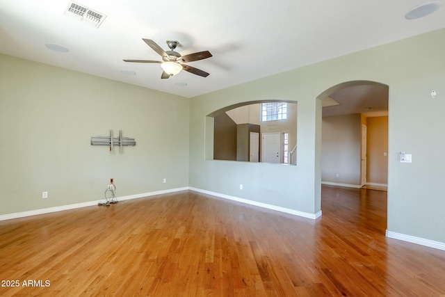 empty room with ceiling fan and hardwood / wood-style floors