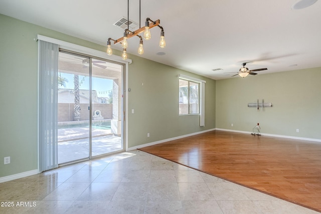 tiled spare room with ceiling fan