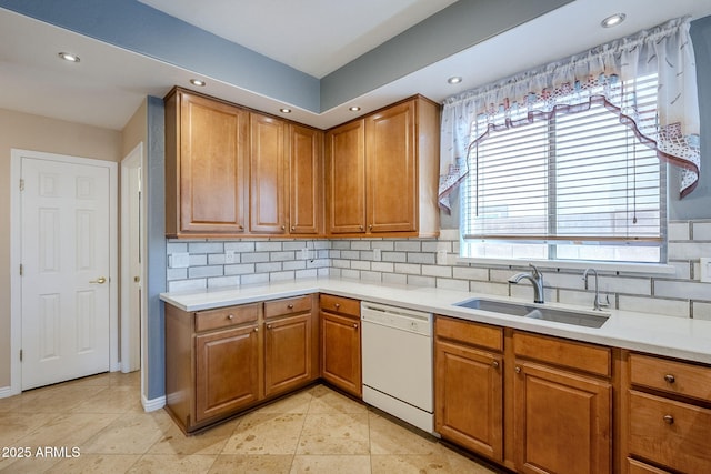 kitchen with decorative backsplash, dishwasher, sink, and light tile patterned flooring