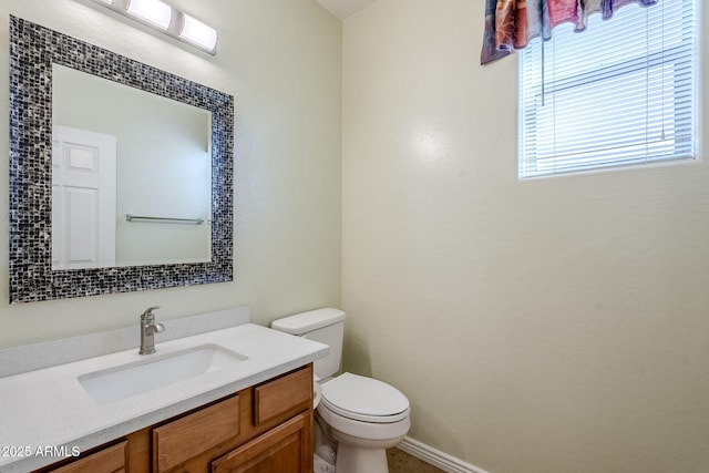 bathroom featuring toilet and vanity