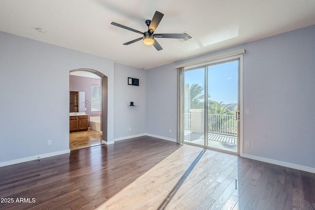 spare room with ceiling fan and dark hardwood / wood-style floors