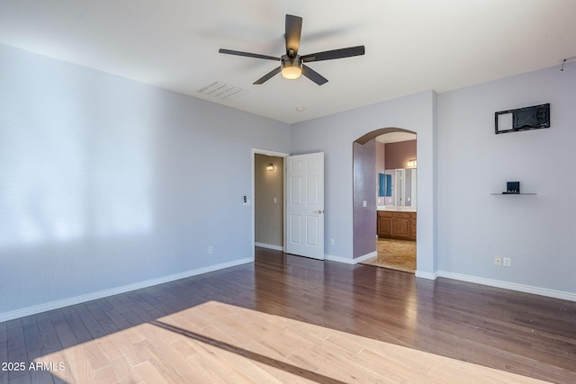 empty room featuring ceiling fan and dark hardwood / wood-style flooring