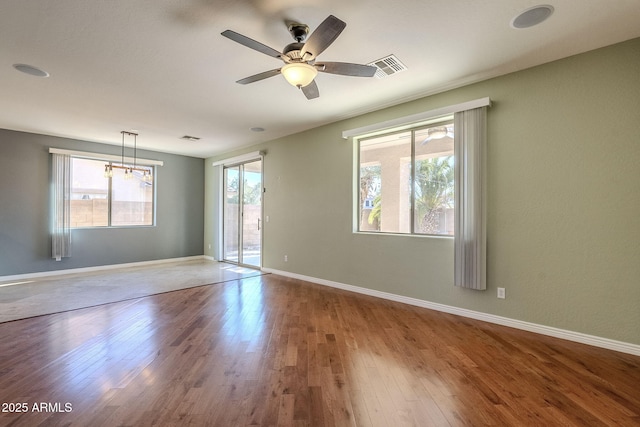 unfurnished room with ceiling fan and hardwood / wood-style flooring