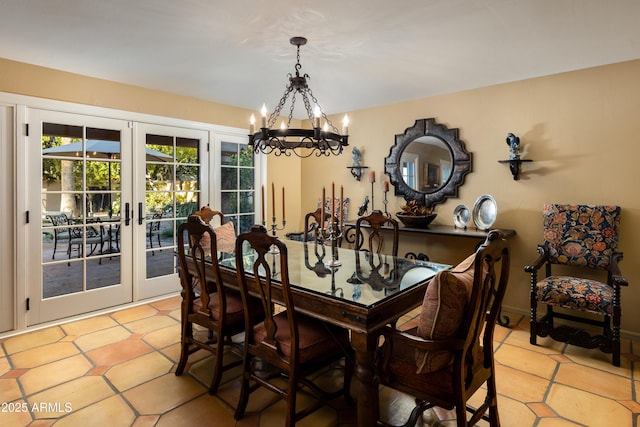 dining room with french doors and a chandelier