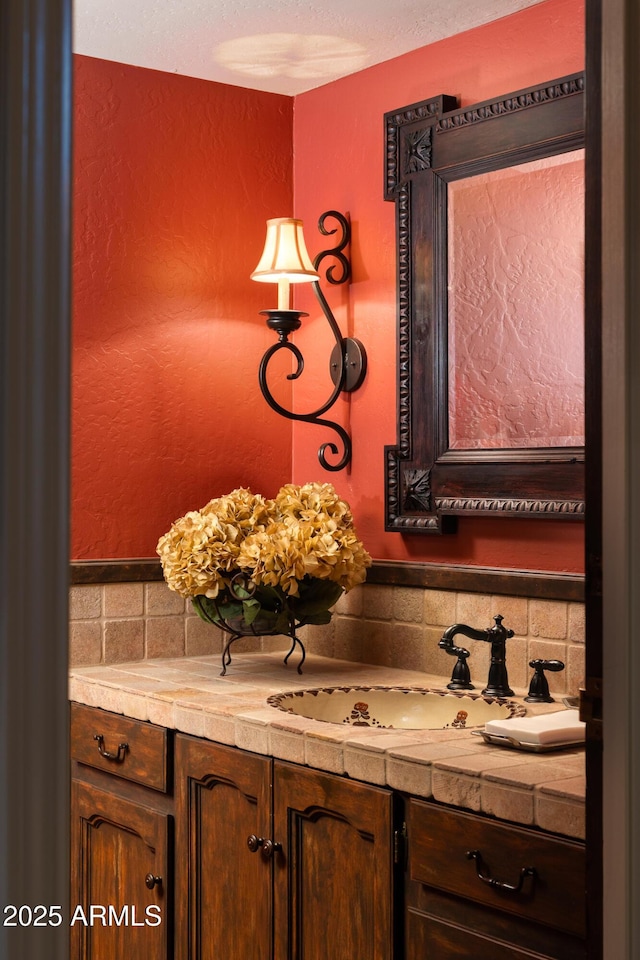 bathroom featuring tasteful backsplash and vanity