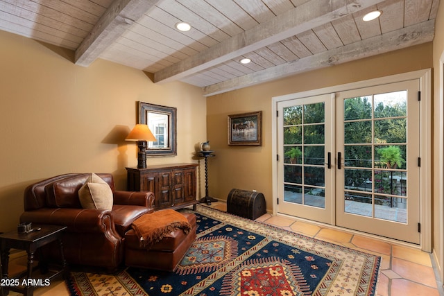 sitting room featuring tile patterned floors, wooden ceiling, french doors, and beamed ceiling