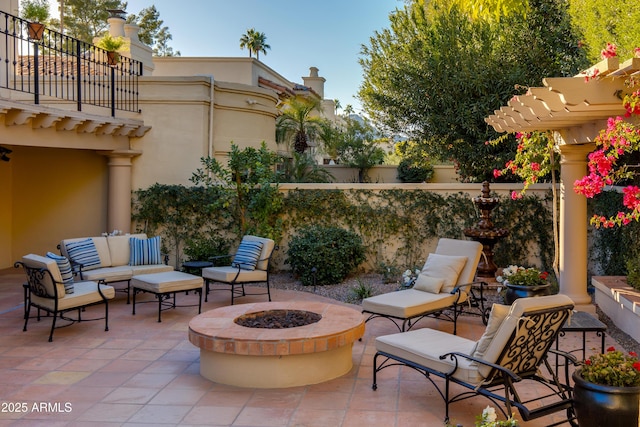 view of patio / terrace featuring an outdoor living space with a fire pit