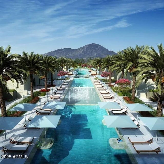 view of swimming pool with a mountain view