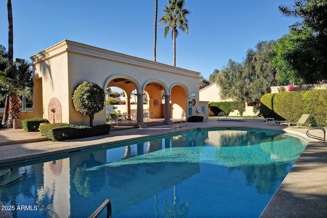 view of swimming pool with a patio area