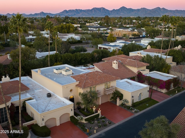 aerial view at dusk featuring a mountain view