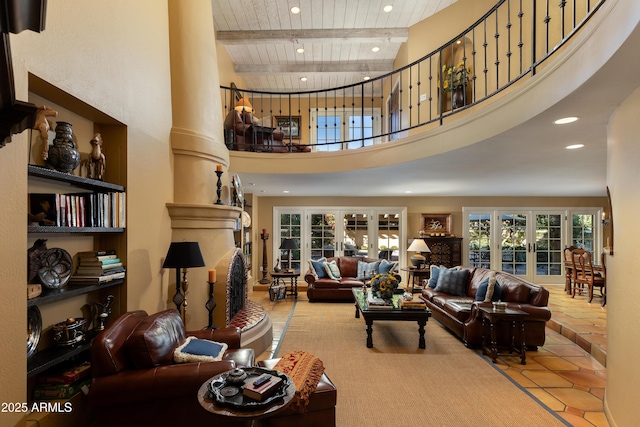 tiled living room featuring a towering ceiling, wooden ceiling, beam ceiling, and french doors