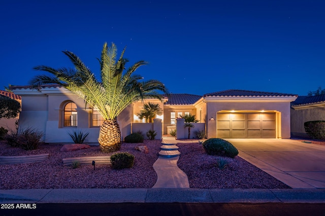 mediterranean / spanish house featuring a garage