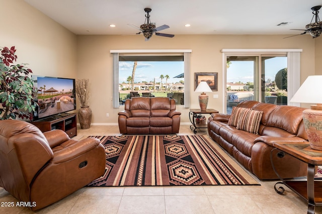 tiled living room featuring plenty of natural light and ceiling fan