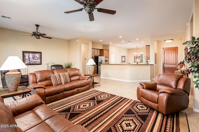 tiled living room featuring ceiling fan