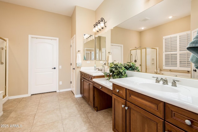 bathroom with tile patterned flooring, vanity, and walk in shower