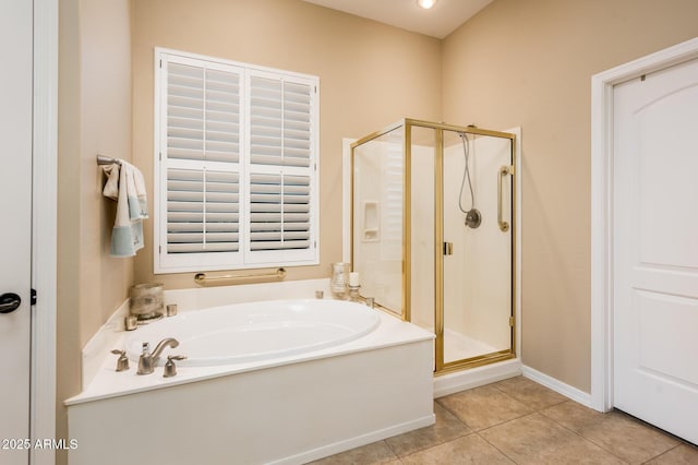 bathroom featuring tile patterned floors and independent shower and bath