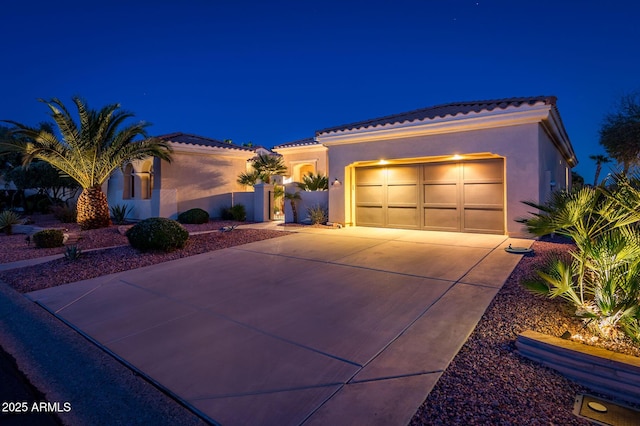 mediterranean / spanish house with a garage