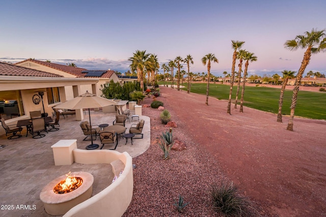 view of community with a patio and a fire pit