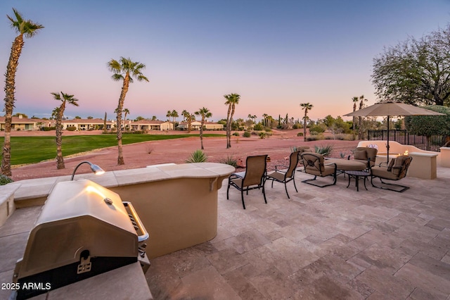 patio terrace at dusk with area for grilling