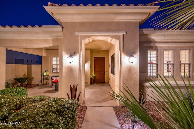 exterior entry at twilight with a patio