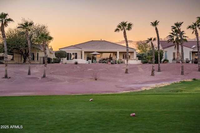 view of community featuring a yard and a patio