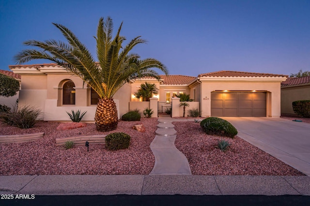 mediterranean / spanish house with a garage