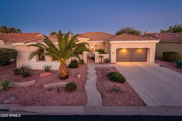 mediterranean / spanish house with a garage