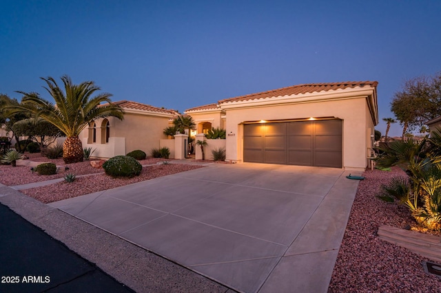 mediterranean / spanish house featuring a garage