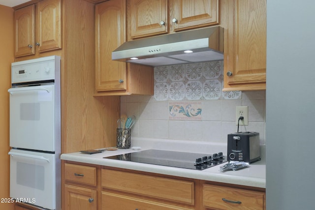 kitchen with decorative backsplash, double oven, and black cooktop