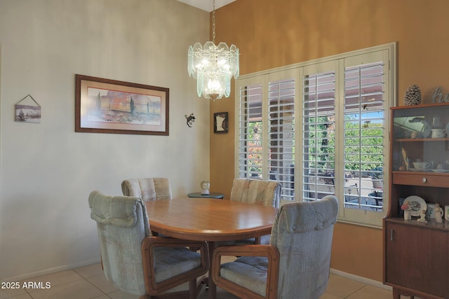 dining space with light tile patterned floors and a notable chandelier