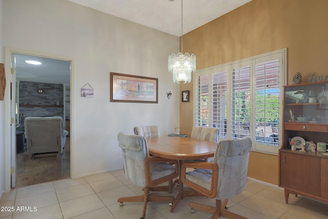 tiled dining space featuring a chandelier