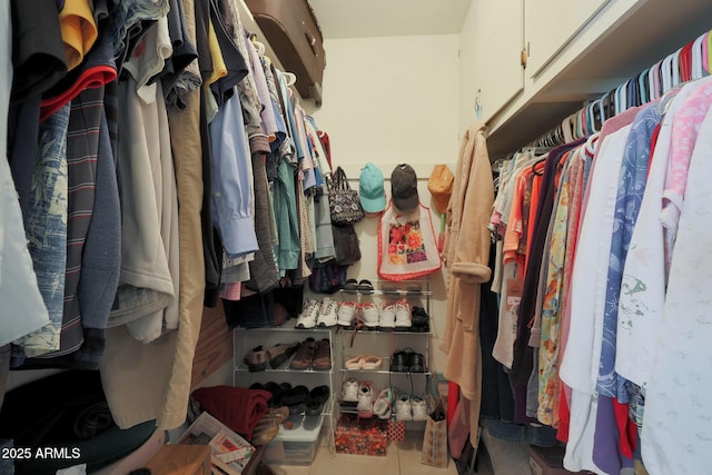 walk in closet featuring tile patterned flooring