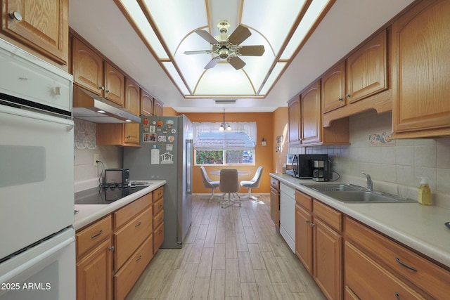 kitchen featuring white dishwasher, hanging light fixtures, ceiling fan, decorative backsplash, and black electric cooktop