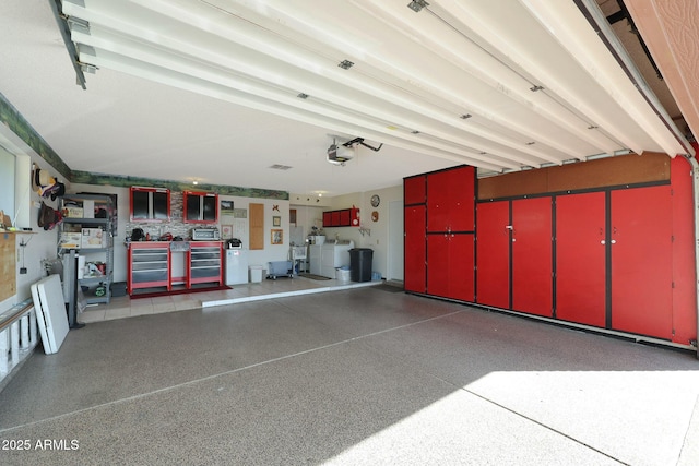 garage featuring separate washer and dryer and a garage door opener