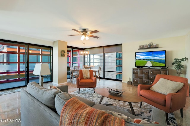 tiled living room with plenty of natural light and ceiling fan with notable chandelier